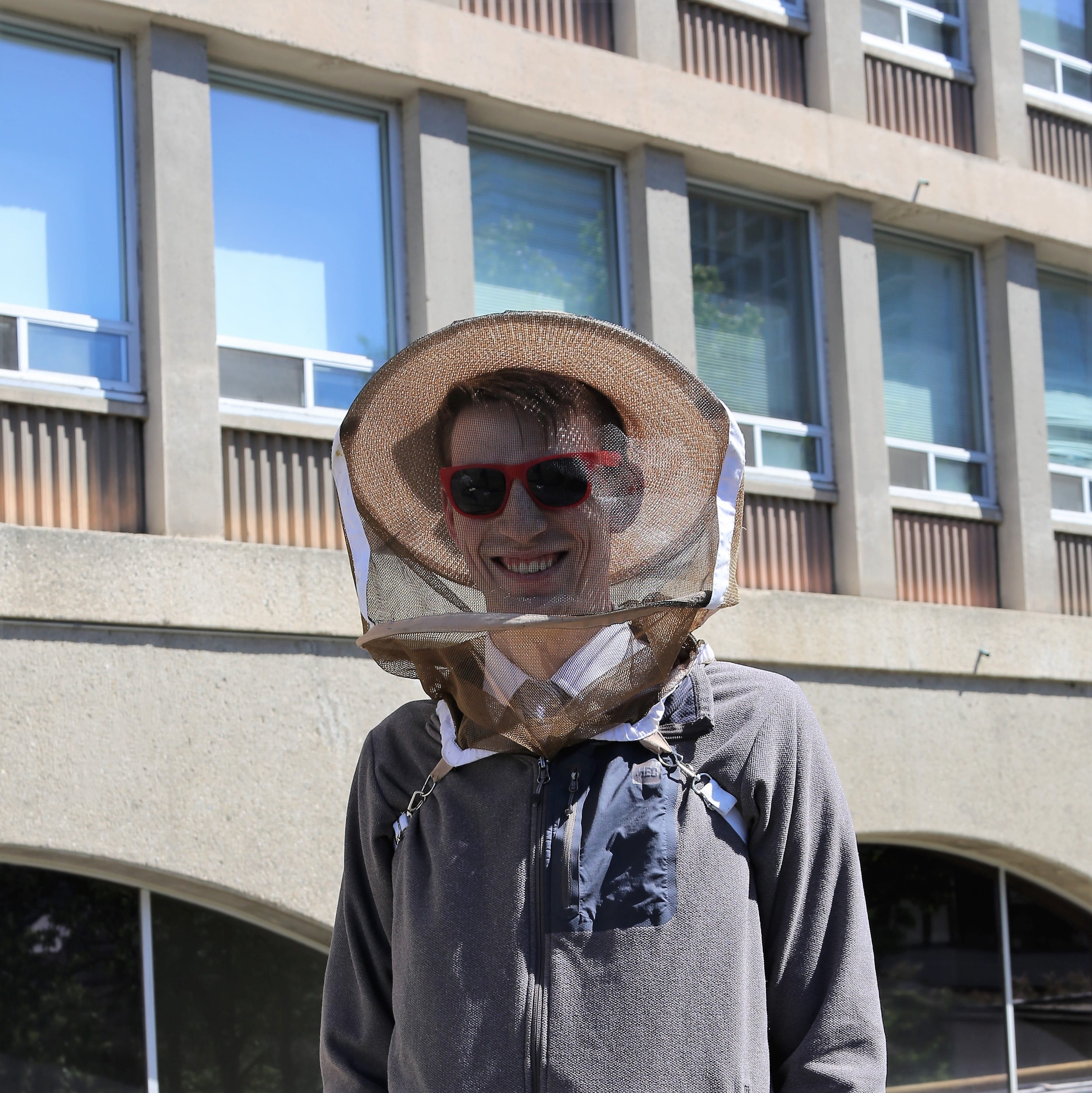 Photo of Ben Coleman wearing a beekeeper mesh hat